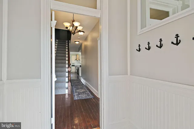 a view of a hallway with wooden floor and staircase