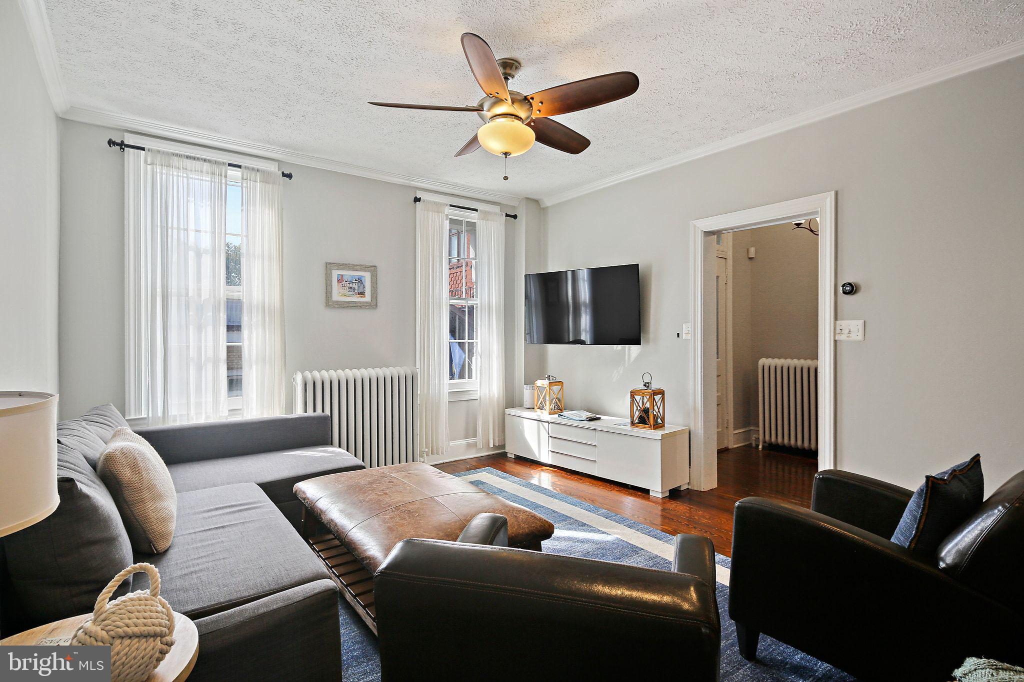 32 East Street Annapolis, MD 21401 - Photo 9 of 34 a living room with furniture ceiling fan and a window