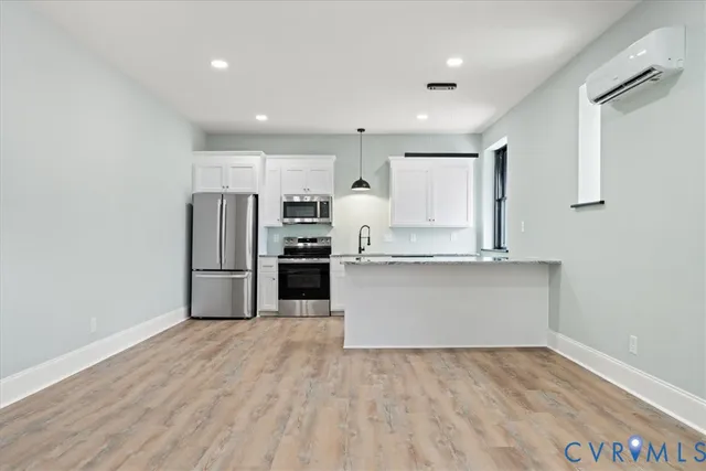 a view of kitchen with stainless steel appliances cabinets
