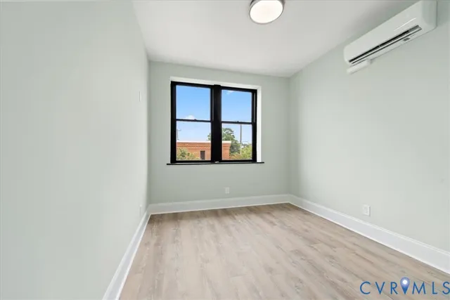 wooden floor in an empty room with a window