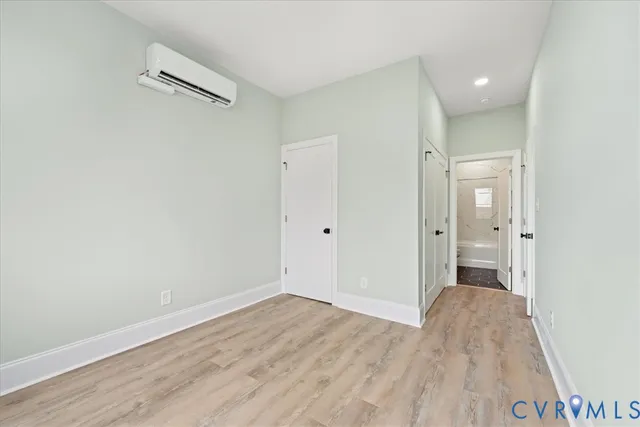 a view of a room with wooden floor and a sink