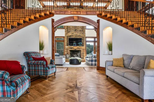 a living room with furniture and stairs
