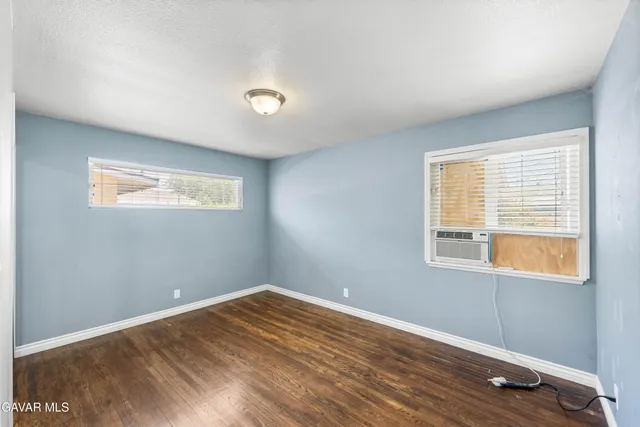 a view of a room with wooden floor and windows