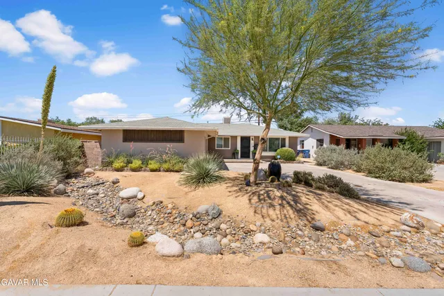 a view of a house with a yard covered with snow in the background