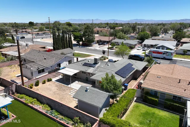 an aerial view of a house with a garden and lake view