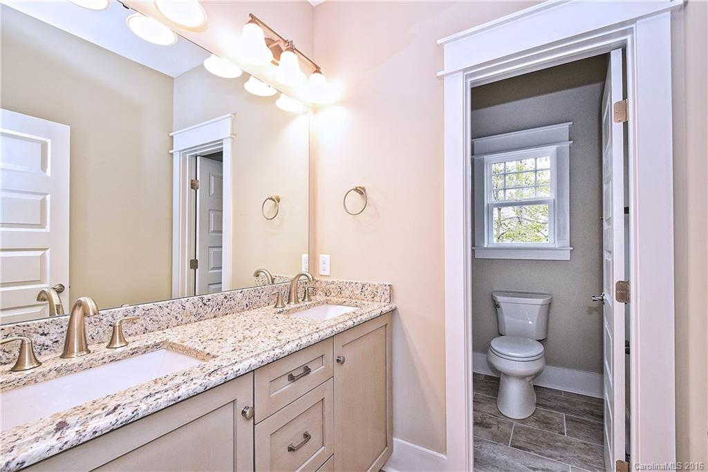 314 McCrary Road Mooresville, NC 28117 - Photo 15 of 20 a bathroom with a granite countertop sink a toilet and a mirror
