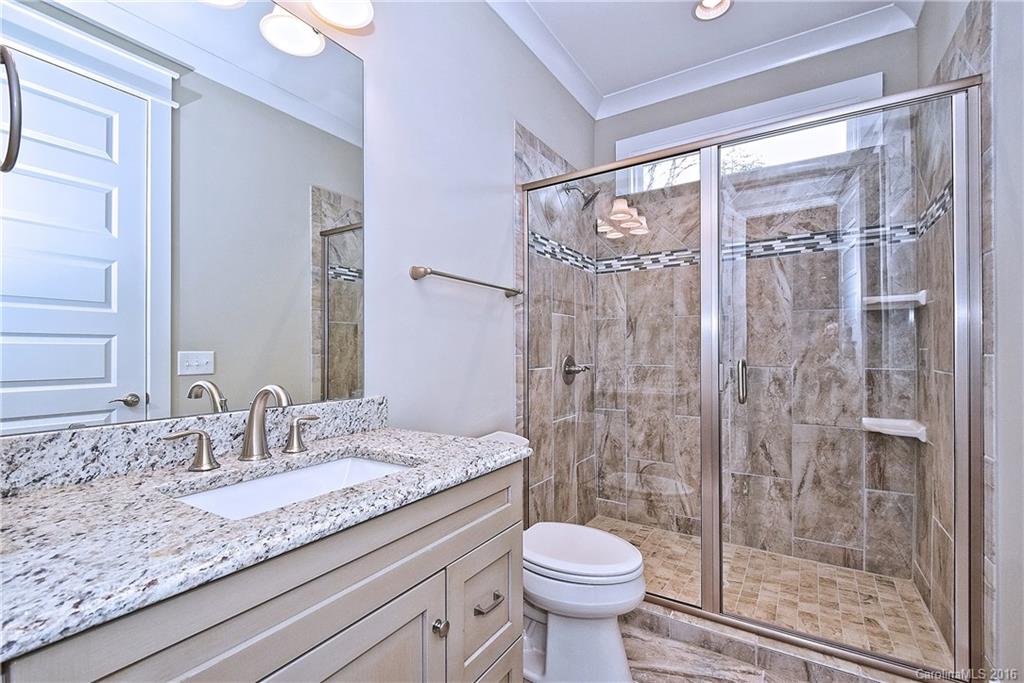 314 McCrary Road Mooresville, NC 28117 - Photo 7 of 20 a bathroom with a granite countertop sink a toilet and shower