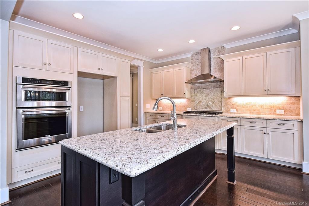 314 McCrary Road Mooresville, NC 28117 - Photo 9 of 20 a kitchen with kitchen island granite countertop a sink stove and refrigerator