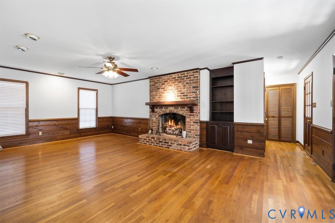 11716 Ivywood Road Chester, VA 23831 - Photo 10 of 38 a view of a livingroom with furniture a fireplace and wooden floor