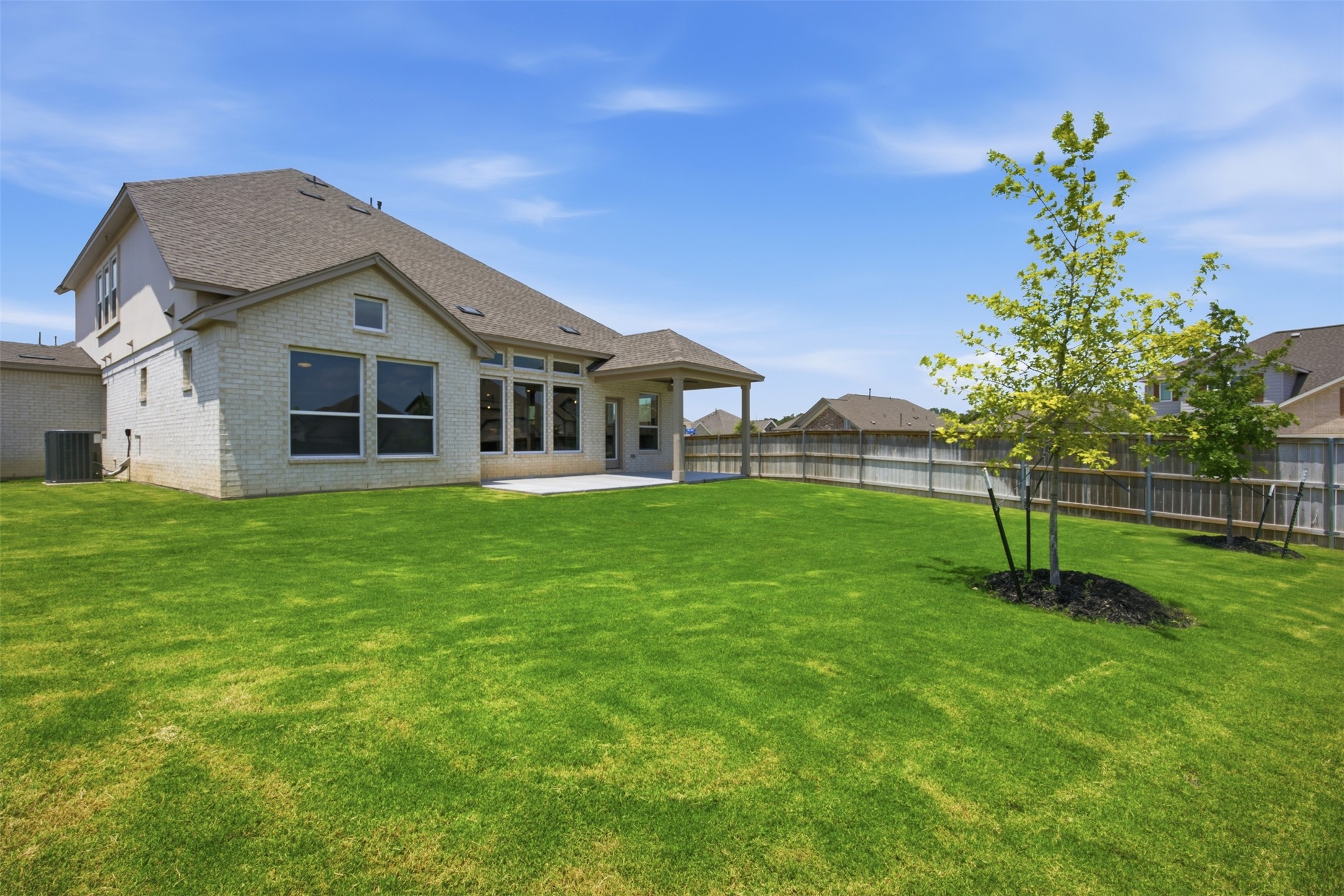 2101 Little Snake Way Georgetown, TX 78633 - Photo 35 of 37 A manicured lawn extends from a covered patio to a private backyard, perfect for outdoor enjoyment.