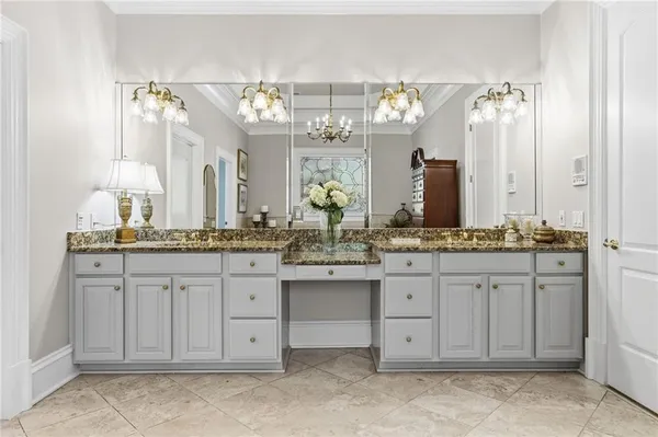 a bathroom with a double vanity sink a toilet and a mirror