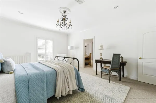 a living room with furniture and a dining table with wooden floor