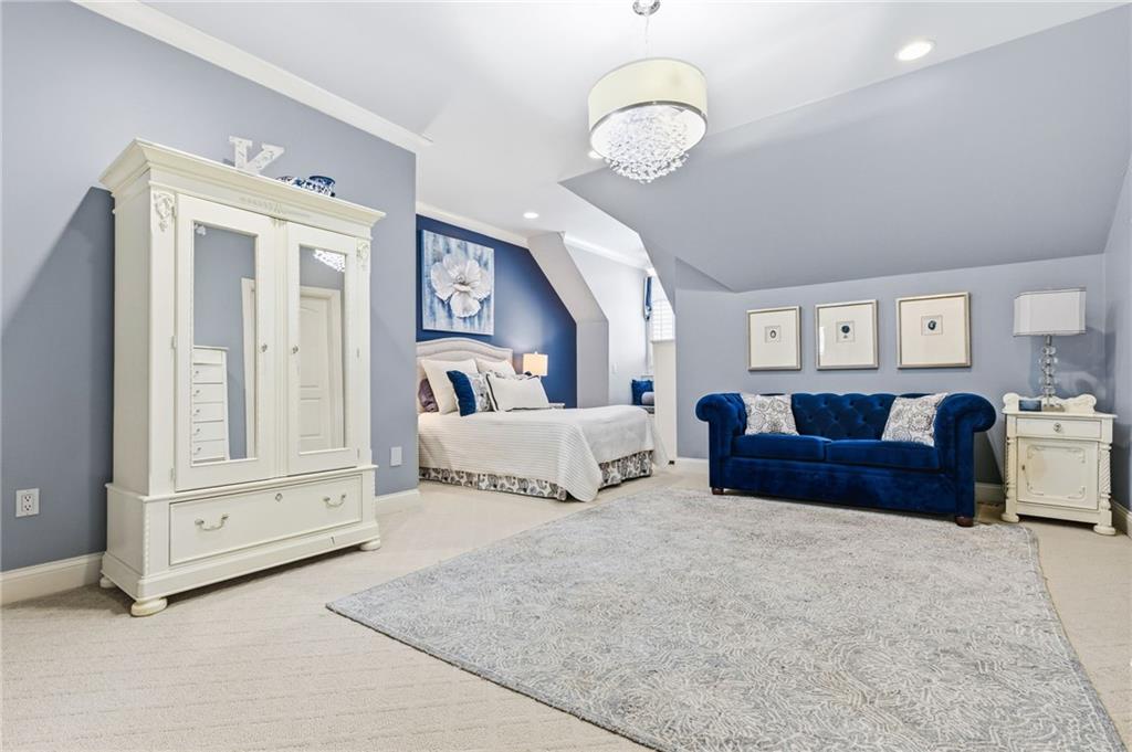 1400 Paul Aiken Road Dallas, GA 30157 - Photo 44 of 62 a bedroom with a large bed and a chandelier