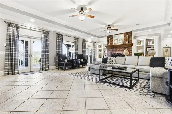 a living room with furniture a chandelier and a fireplace