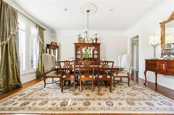 a living room with furniture a fireplace and a chandelier