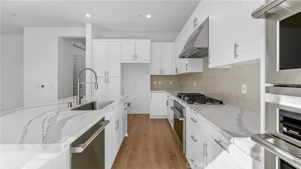 a kitchen with a sink stove and cabinets