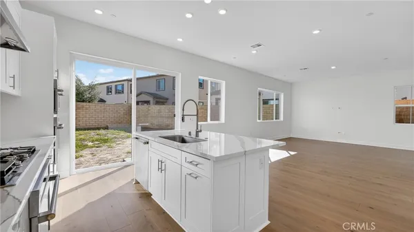 a bathroom with a granite countertop sink and a large mirror