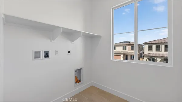 a view of storage and utility room with a window