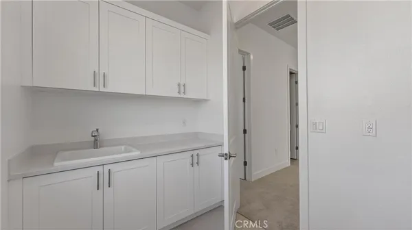 a kitchen with white cabinets