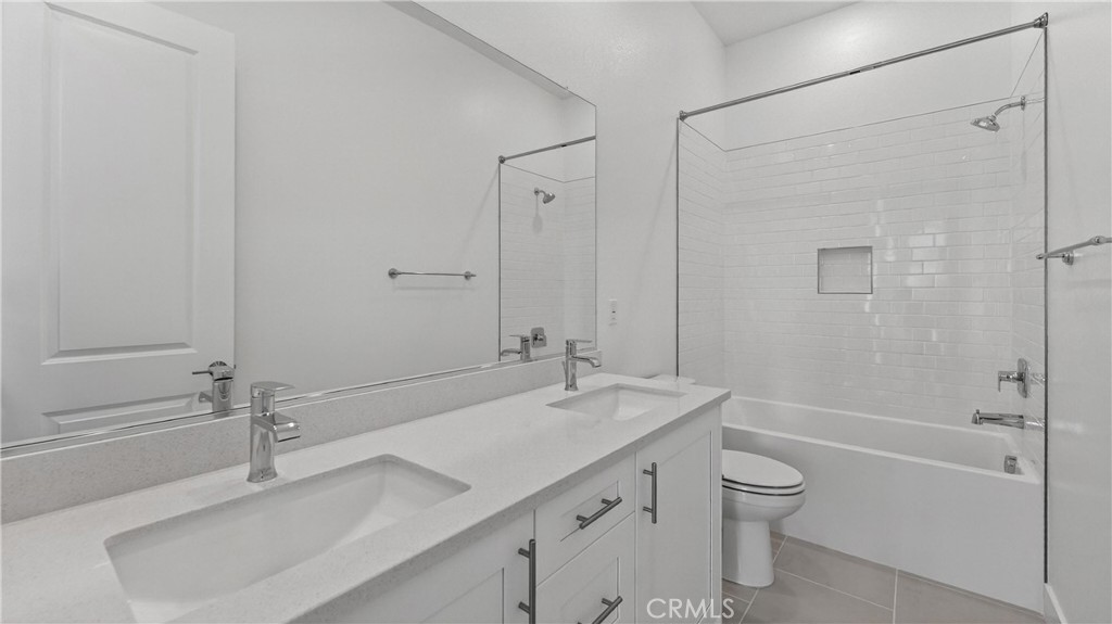 107 Pansy Irvine, CA 92618 - Photo 21 of 35 a bathroom with a granite countertop sink a toilet and shower