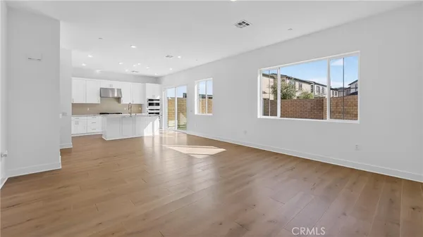 a view of a kitchen with cabinets and wooden floor