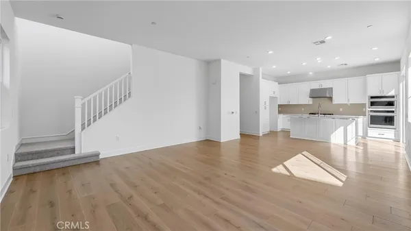 a view of kitchen with cabinets and wooden floor