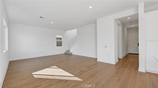 an empty room with wooden floor