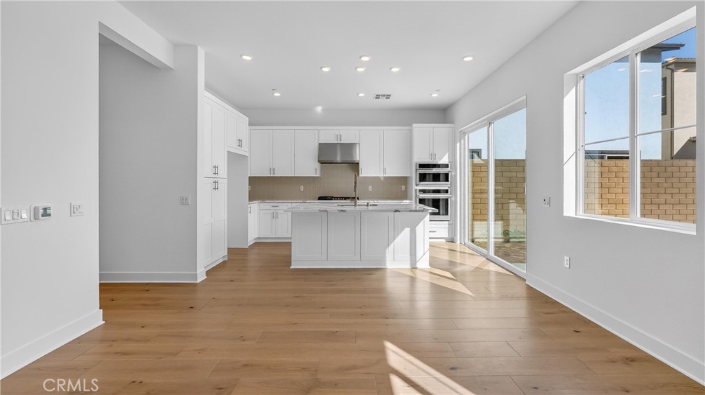 107 Pansy Irvine, CA 92618 - Photo 8 of 35 a view of kitchen with cabinets and wooden floor