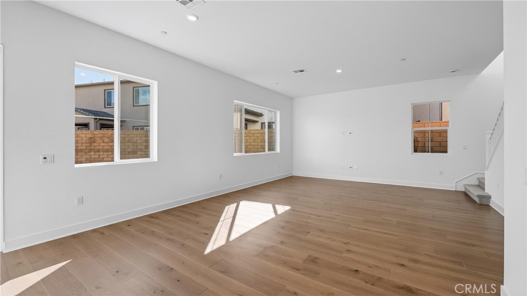 107 Pansy Irvine, CA 92618 - Photo 9 of 35 a view of an empty room with wooden floor and a window