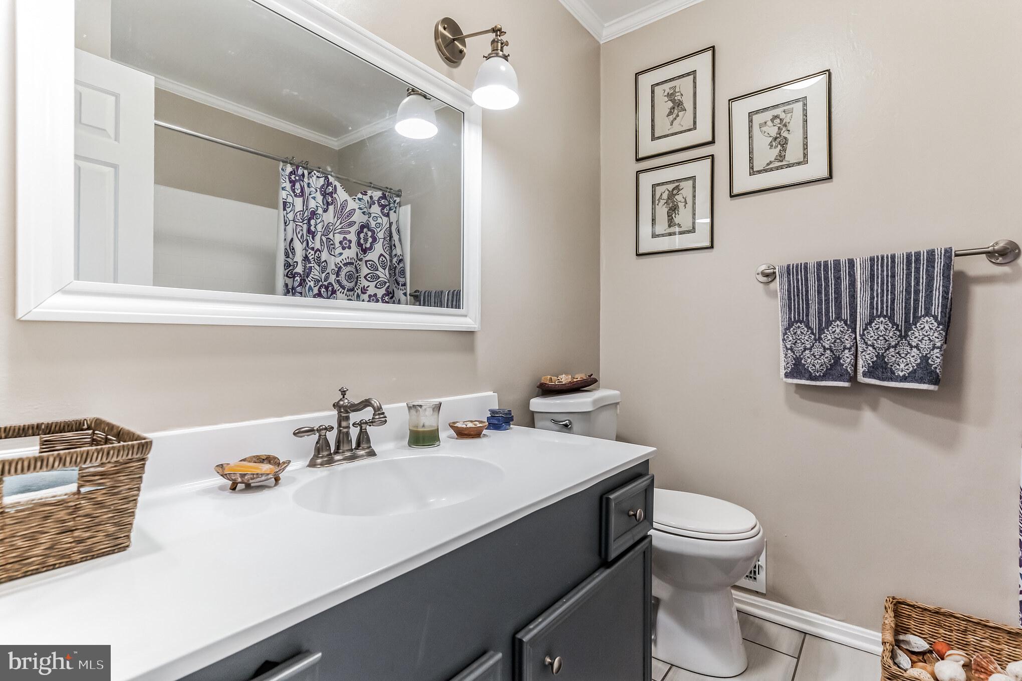 9329 Harvey Road Silver Spring, MD 20910 - Photo 22 of 40 a bathroom with a sink mirror vanity and toilet