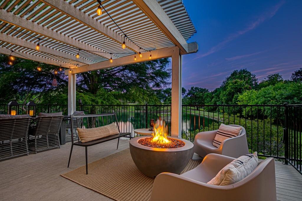 a patio with couches fire pit and outdoor seating