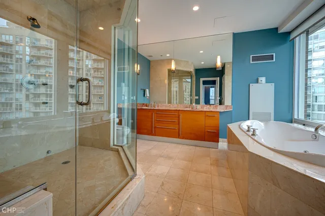 a bathroom with a tub a sink and mirrors