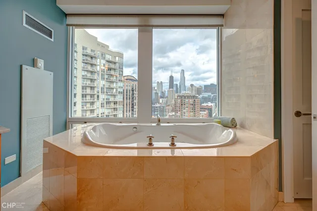 a bath tub sitting in a bathroom next to a window