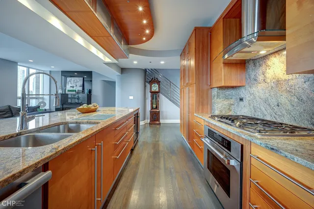 a kitchen with stainless steel appliances granite countertop a stove and a sink