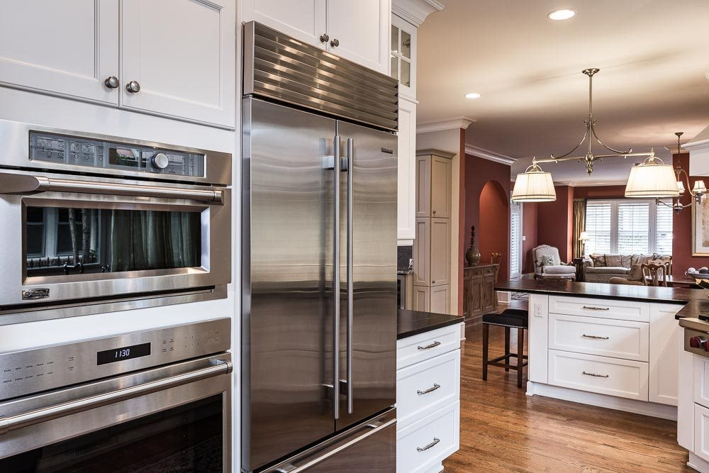 1913 Reid Street Raleigh, NC 27608 - Photo 11 of 30 a kitchen with stainless steel appliances kitchen island granite countertop a stove and cabinets