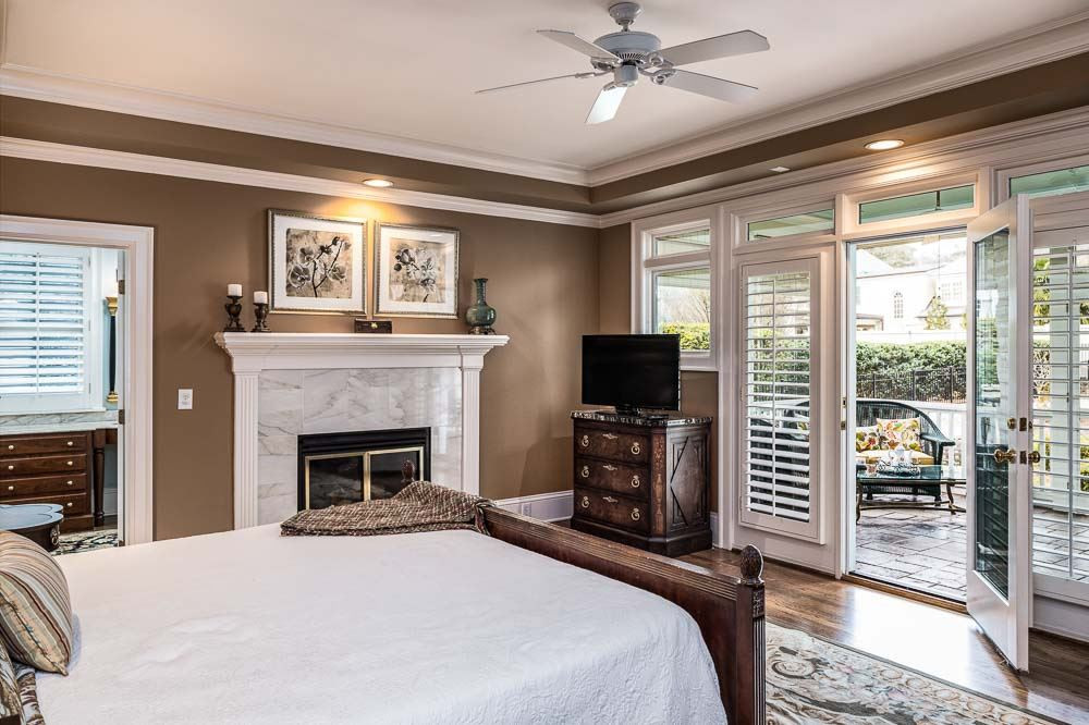 1913 Reid Street Raleigh, NC 27608 - Photo 16 of 30 a bedroom with a bed and a flat screen tv