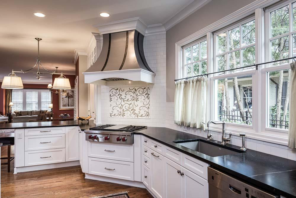 1913 Reid Street Raleigh, NC 27608 - Photo 9 of 30 a kitchen with stainless steel appliances a sink a stove and a window