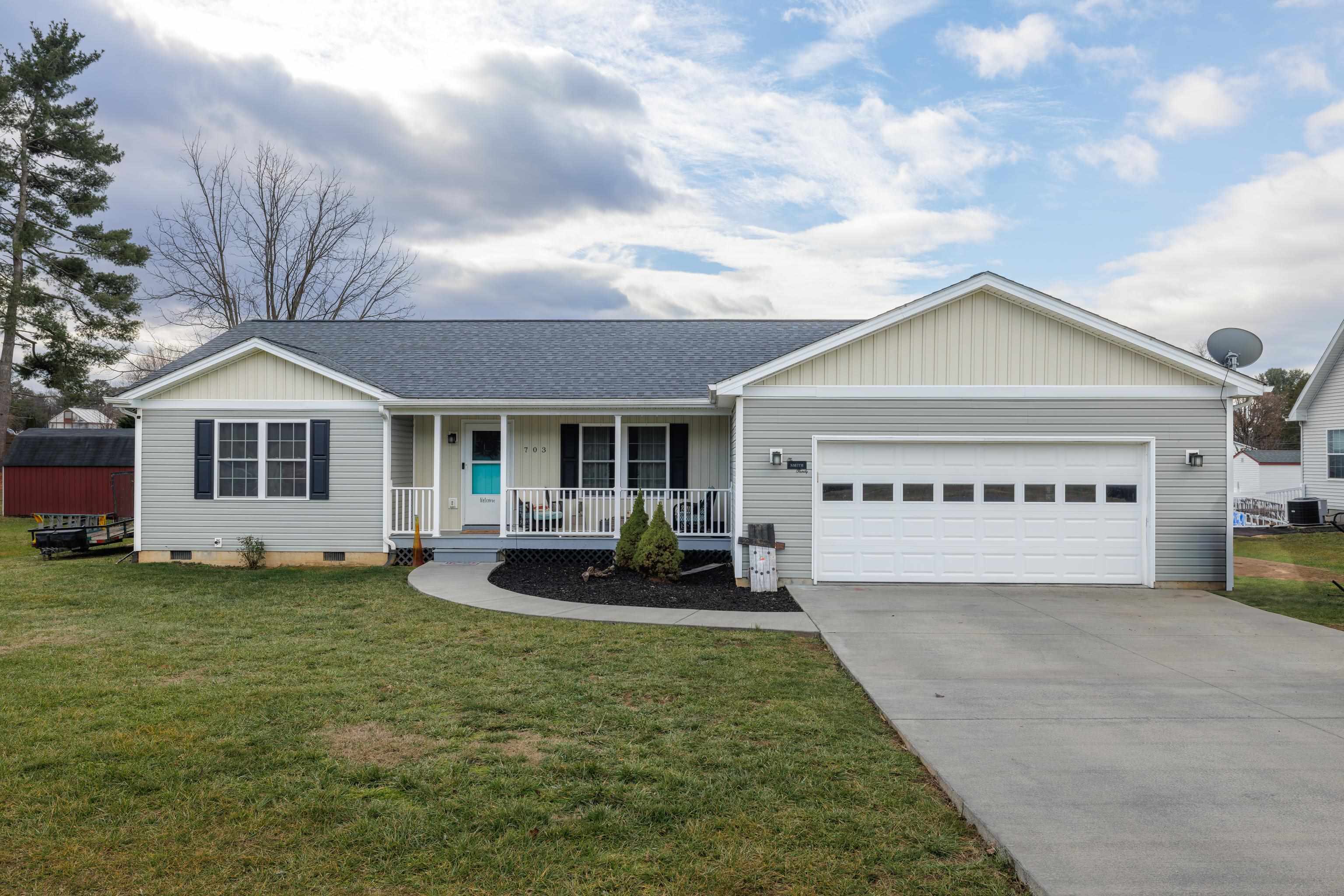 703 14th Street Grottoes, VA 24441 - Photo 1 of 51 a front view of a house with a garden and yard