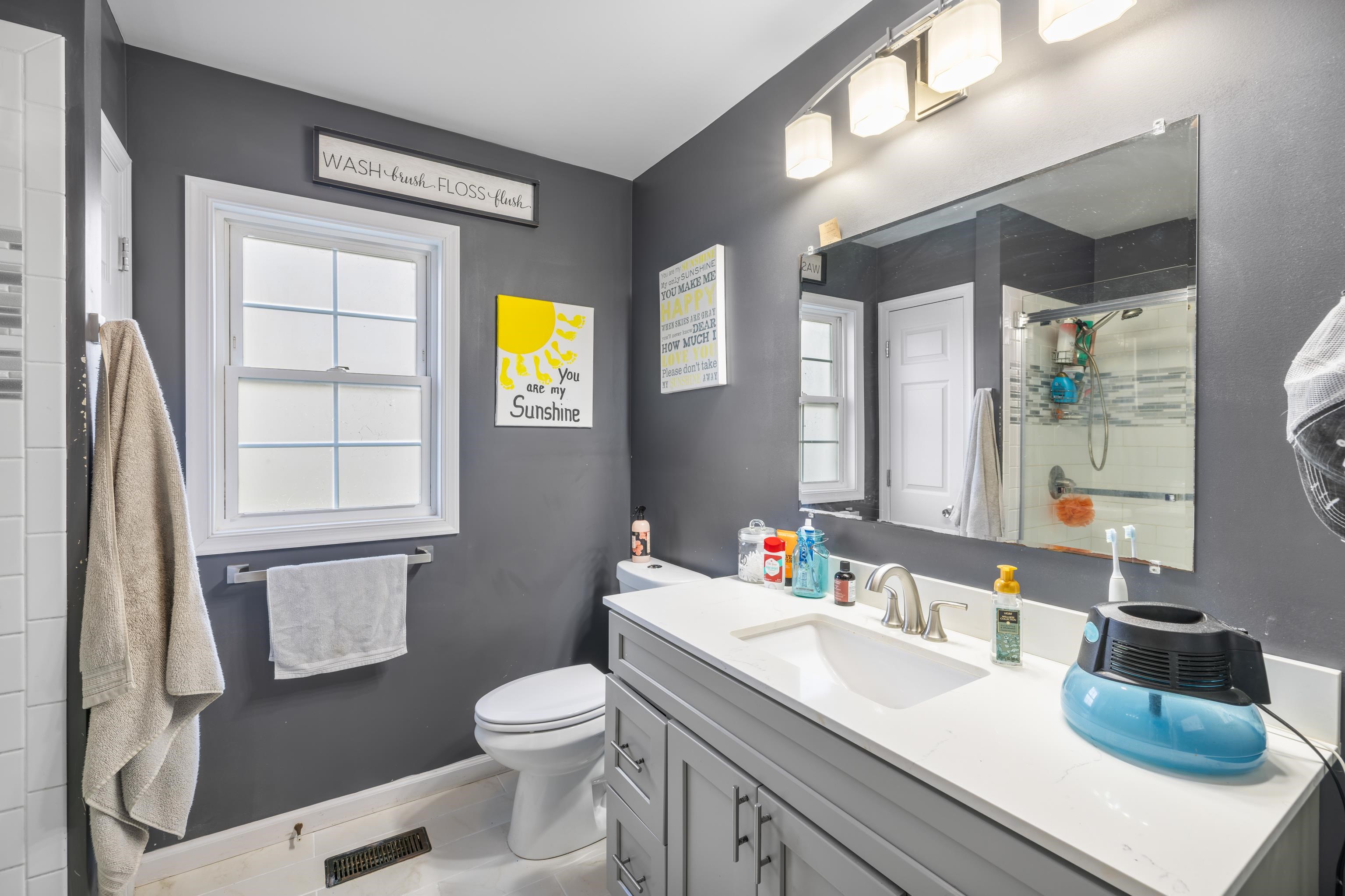 703 14th Street Grottoes, VA 24441 - Photo 18 of 51 a bathroom with a sink a toilet and a large mirror
