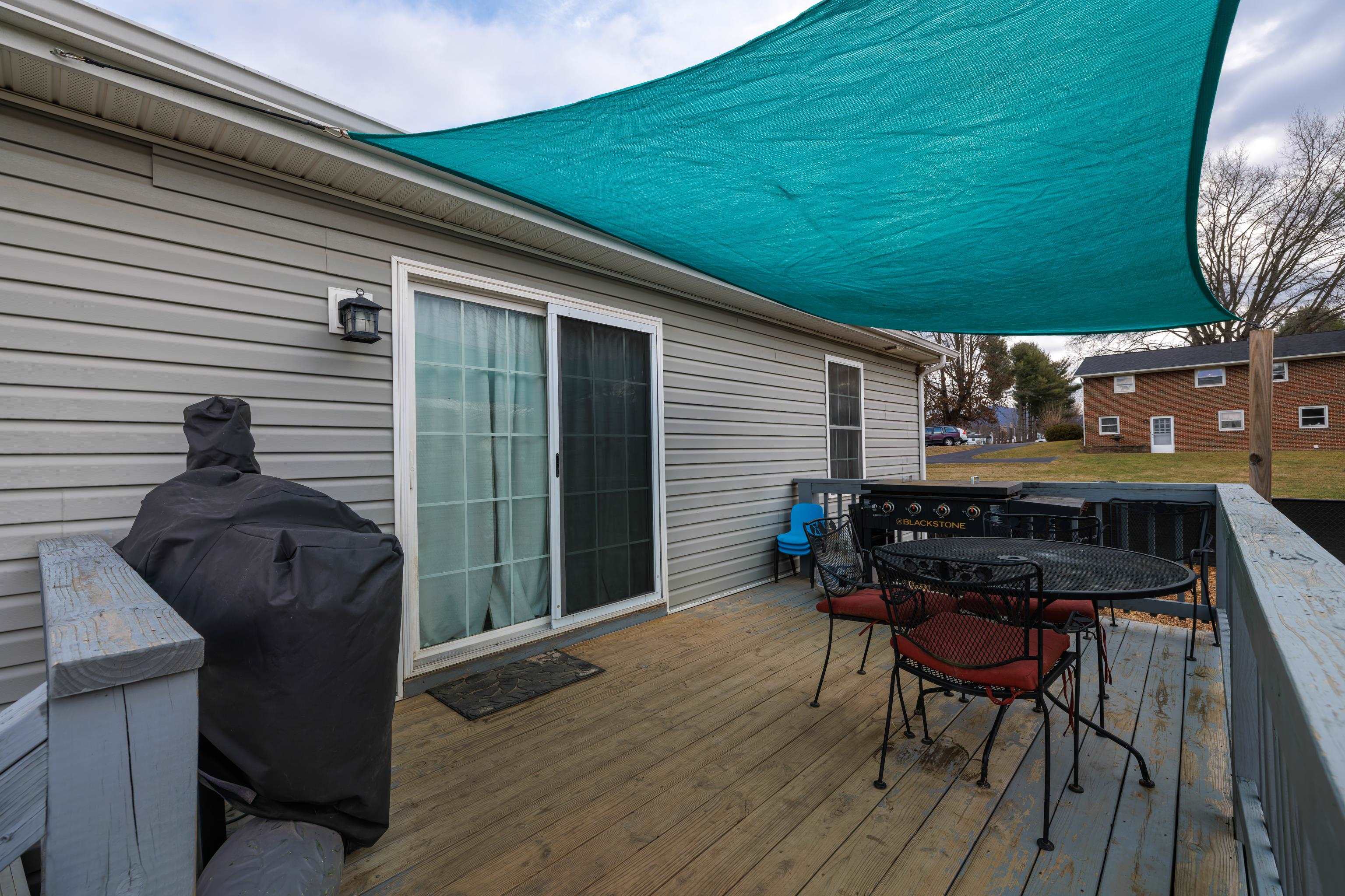 703 14th Street Grottoes, VA 24441 - Photo 31 of 51 a view of a patio with table and chairs with wooden floor and fence