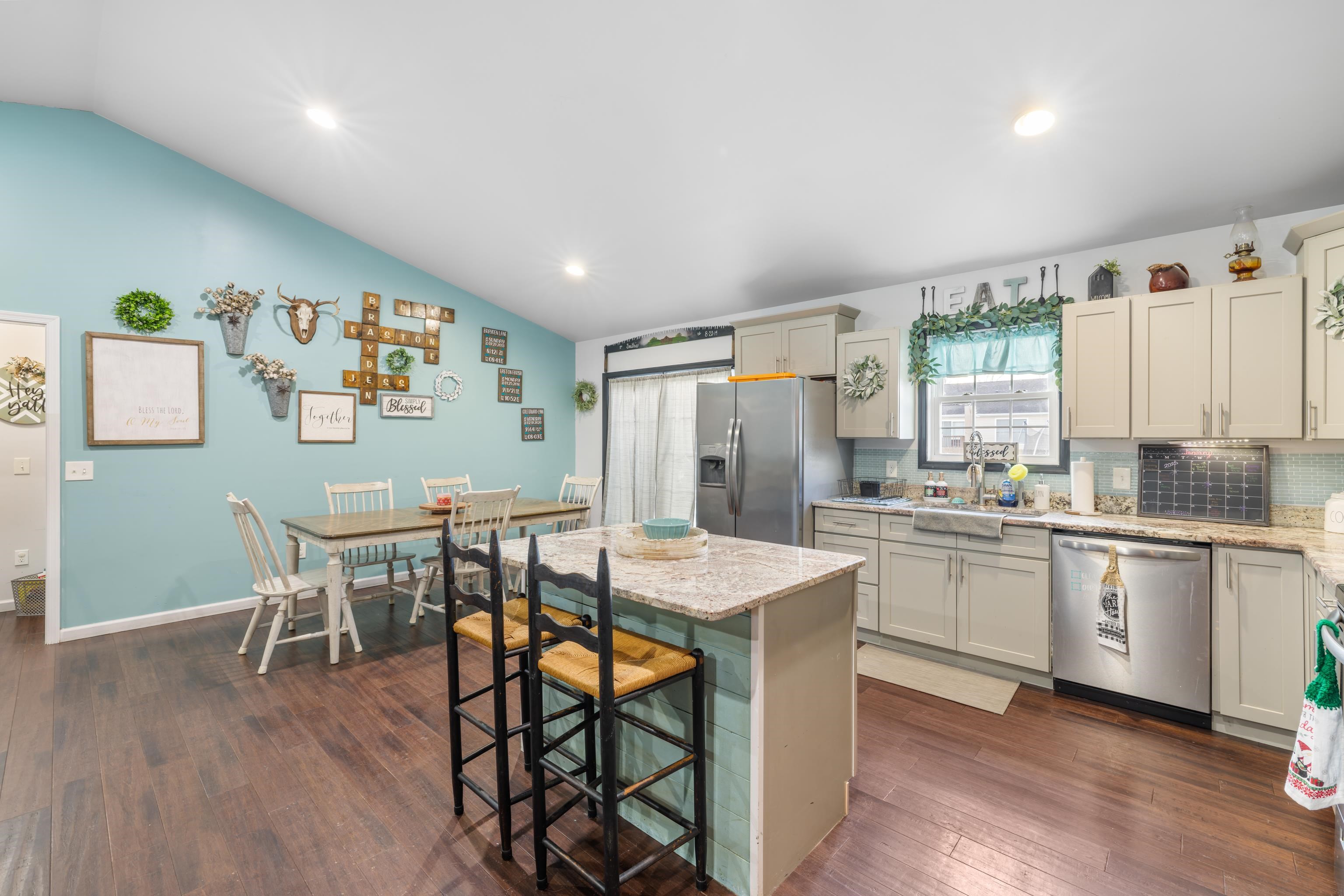 703 14th Street Grottoes, VA 24441 - Photo 7 of 51 a kitchen with stainless steel appliances granite countertop a stove a sink dishwasher and a refrigerator with wooden floor