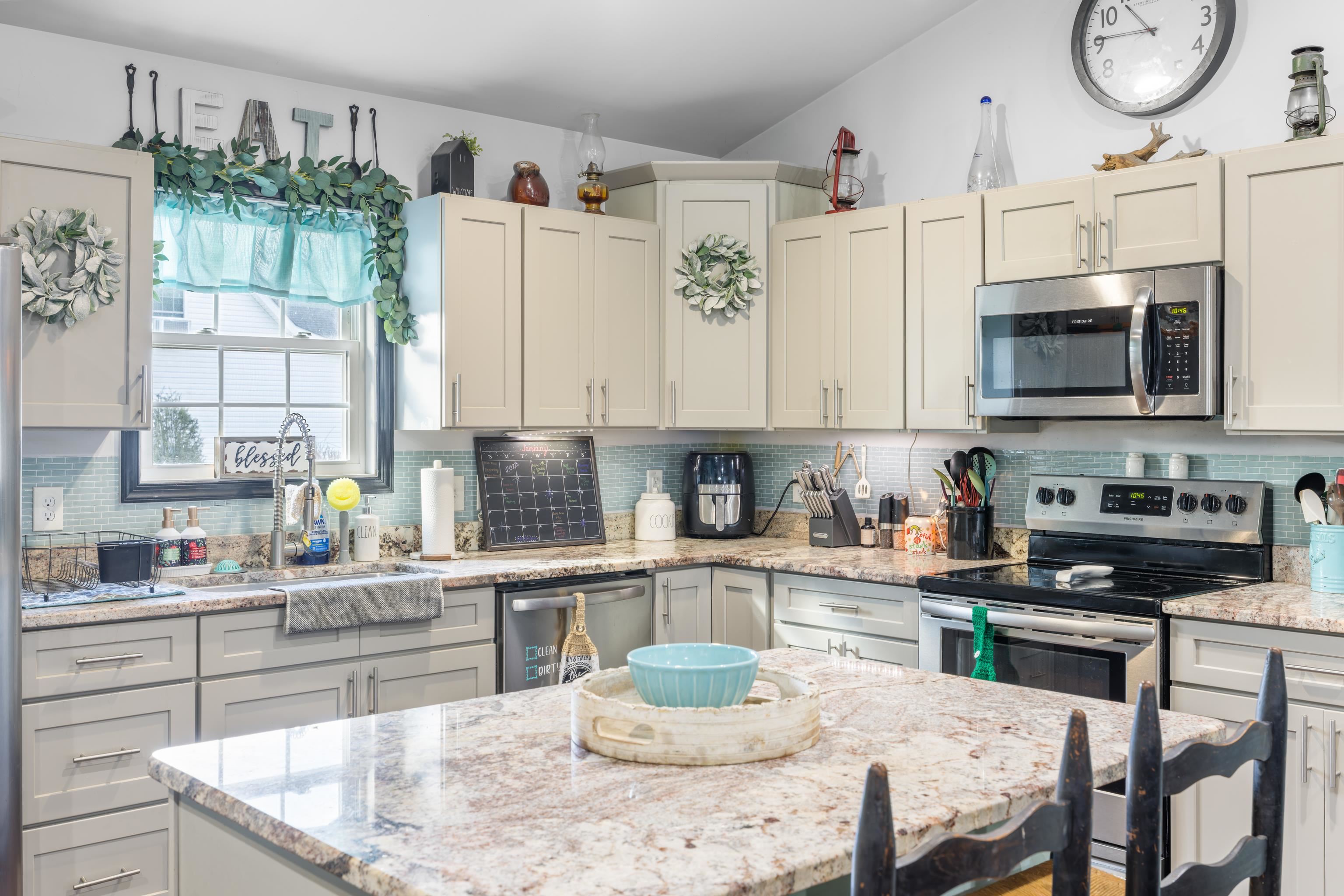 703 14th Street Grottoes, VA 24441 - Photo 9 of 51 a kitchen with stainless steel appliances kitchen island granite countertop a table chairs sink and cabinets