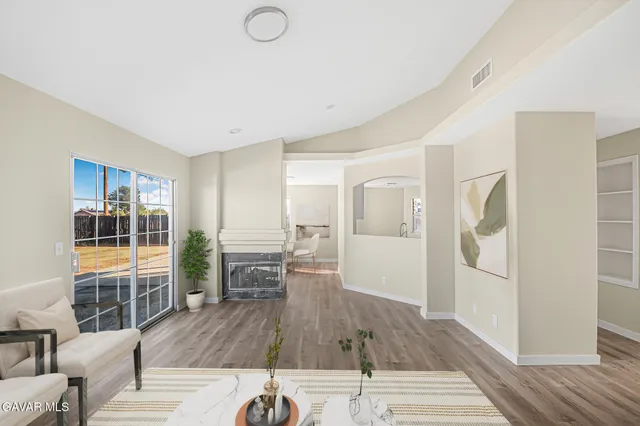 a view of a livingroom with furniture and hardwood floor