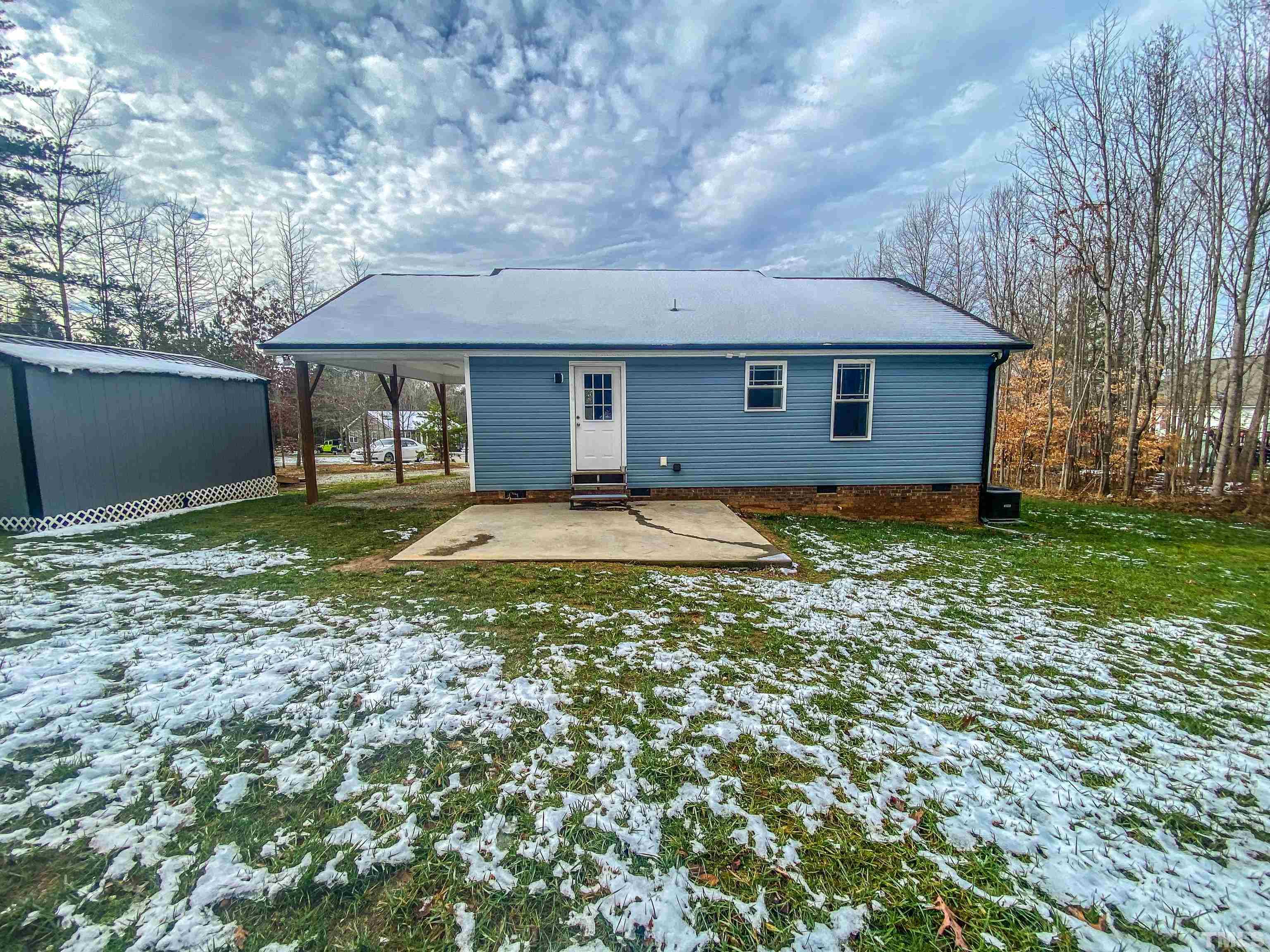 45 Eli Court Roxboro, NC 27573 - Photo 11 of 36 a backyard of a house with yard and outdoor seating