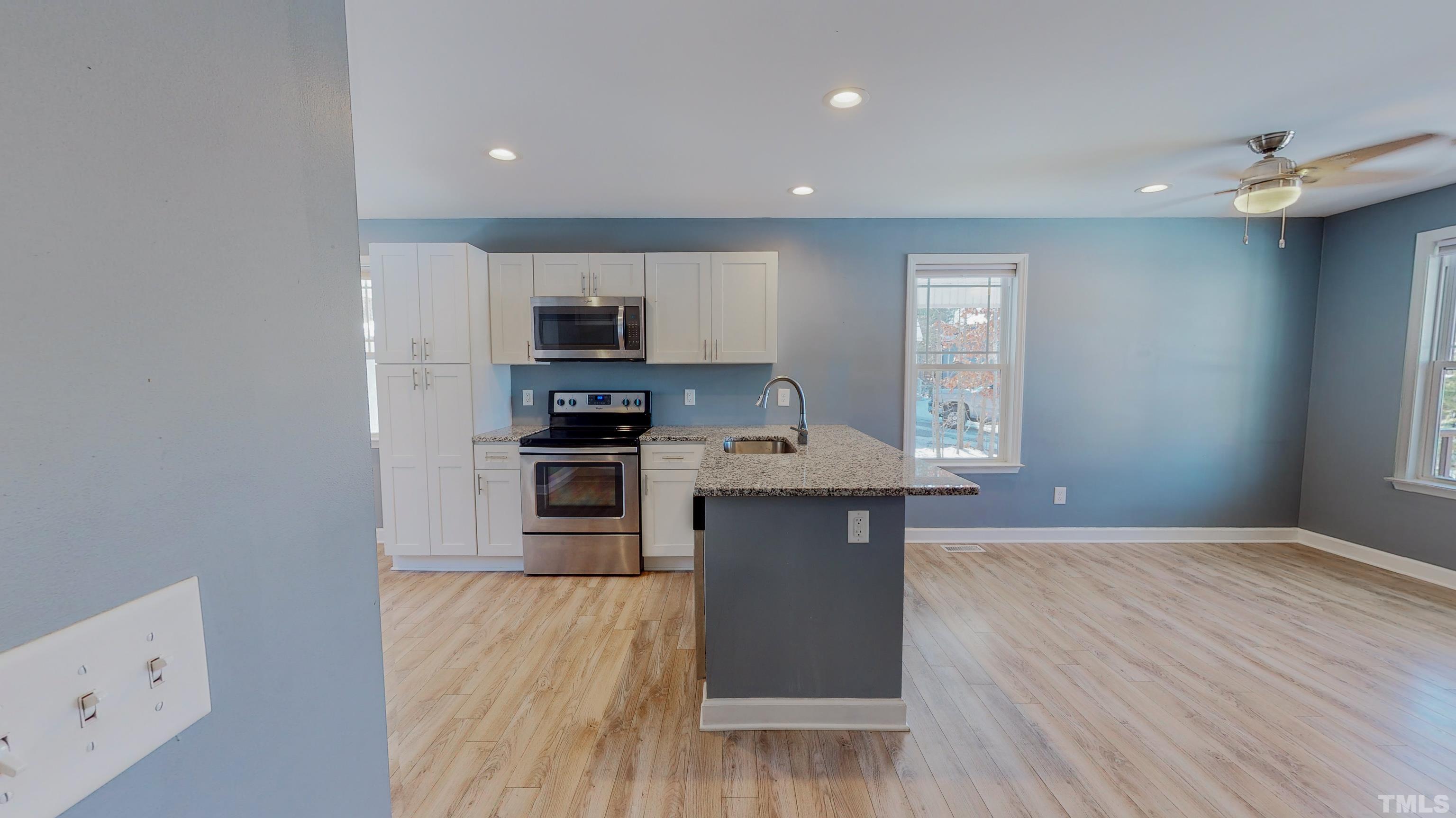 45 Eli Court Roxboro, NC 27573 - Photo 13 of 36 a kitchen with stainless steel appliances granite countertop a stove a sink and a refrigerator