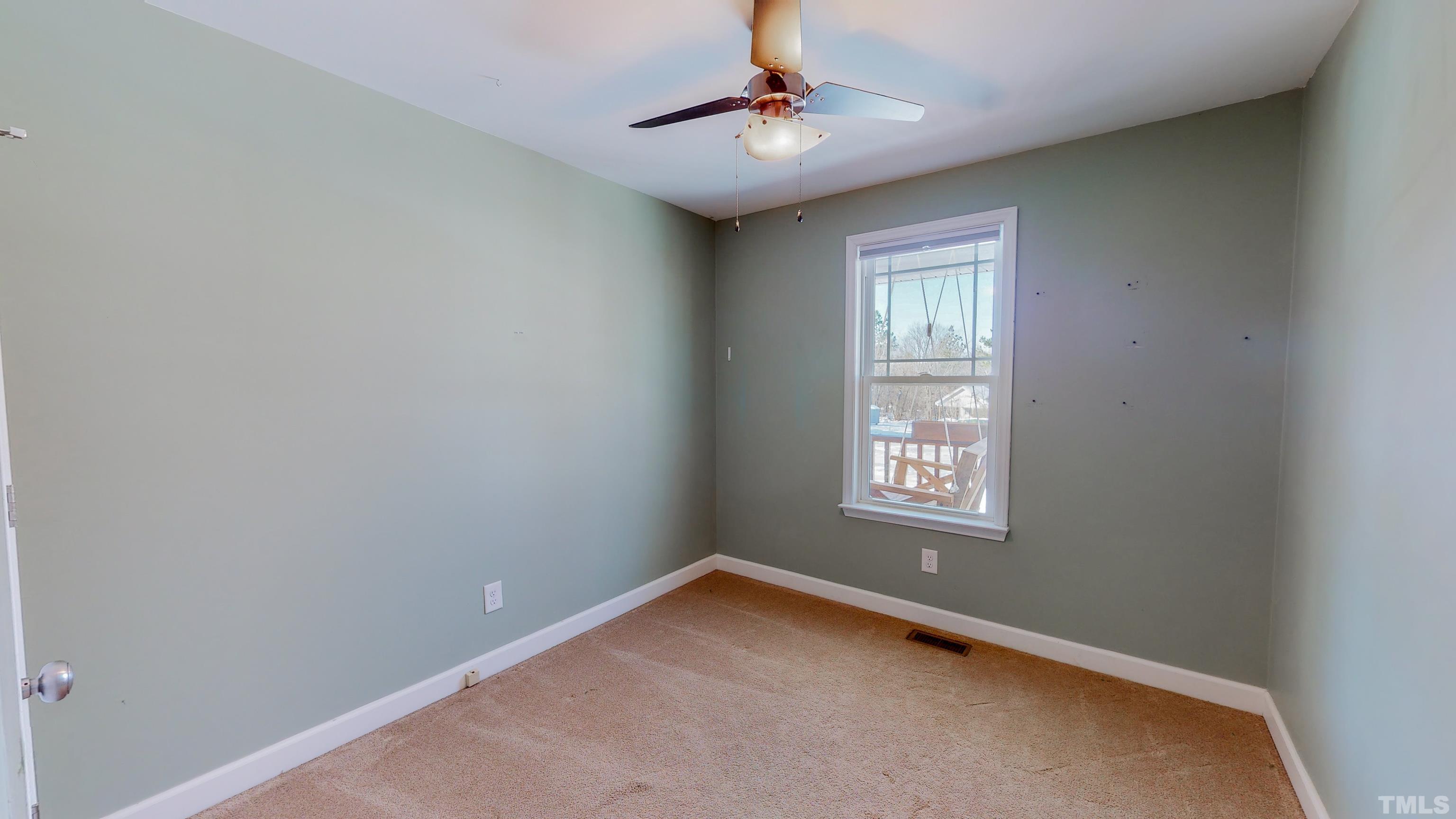 45 Eli Court Roxboro, NC 27573 - Photo 19 of 36 an empty room with a window and ceiling fan