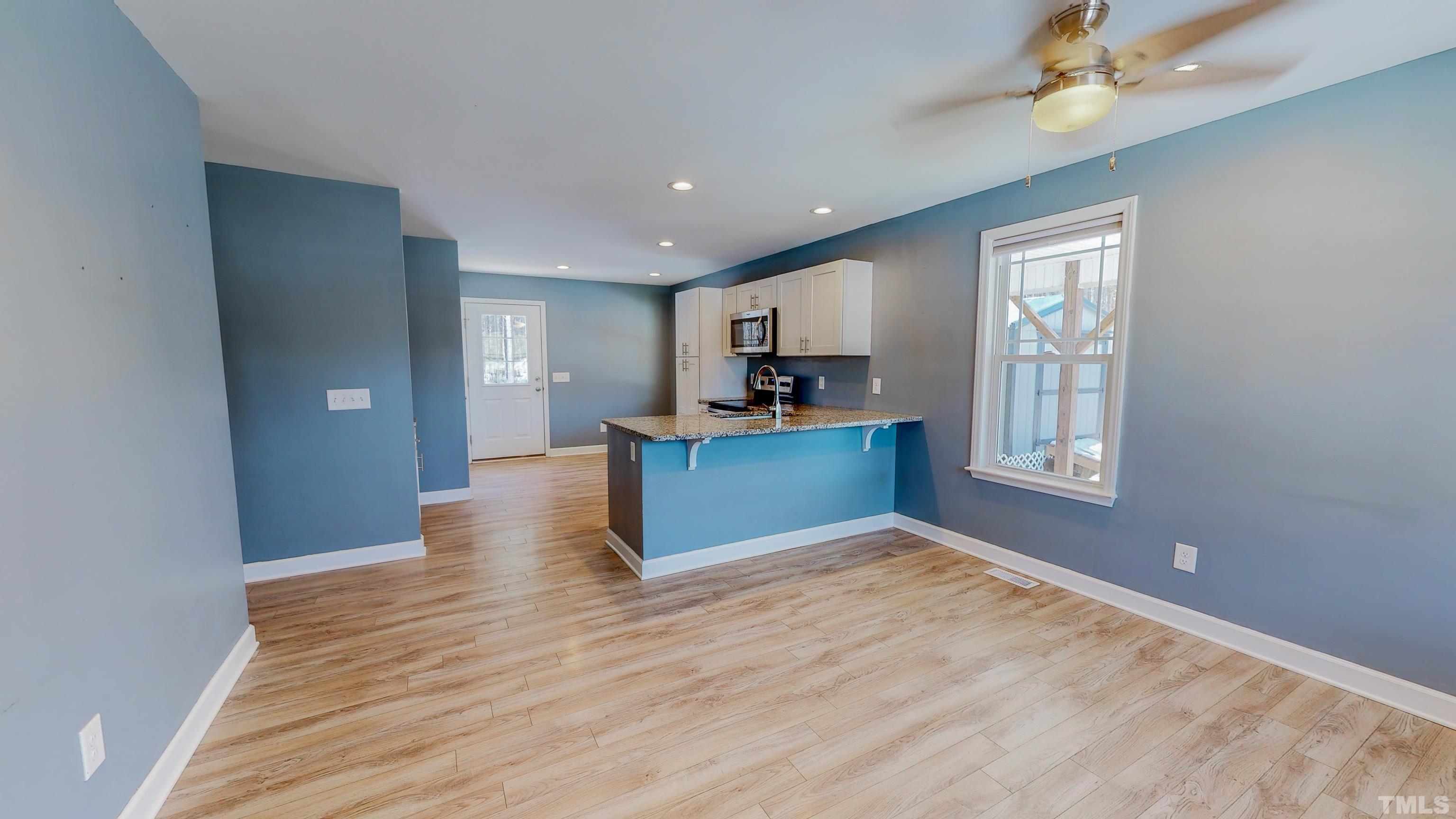 45 Eli Court Roxboro, NC 27573 - Photo 3 of 36 a view of kitchen with kitchen island wooden floor and refrigerator