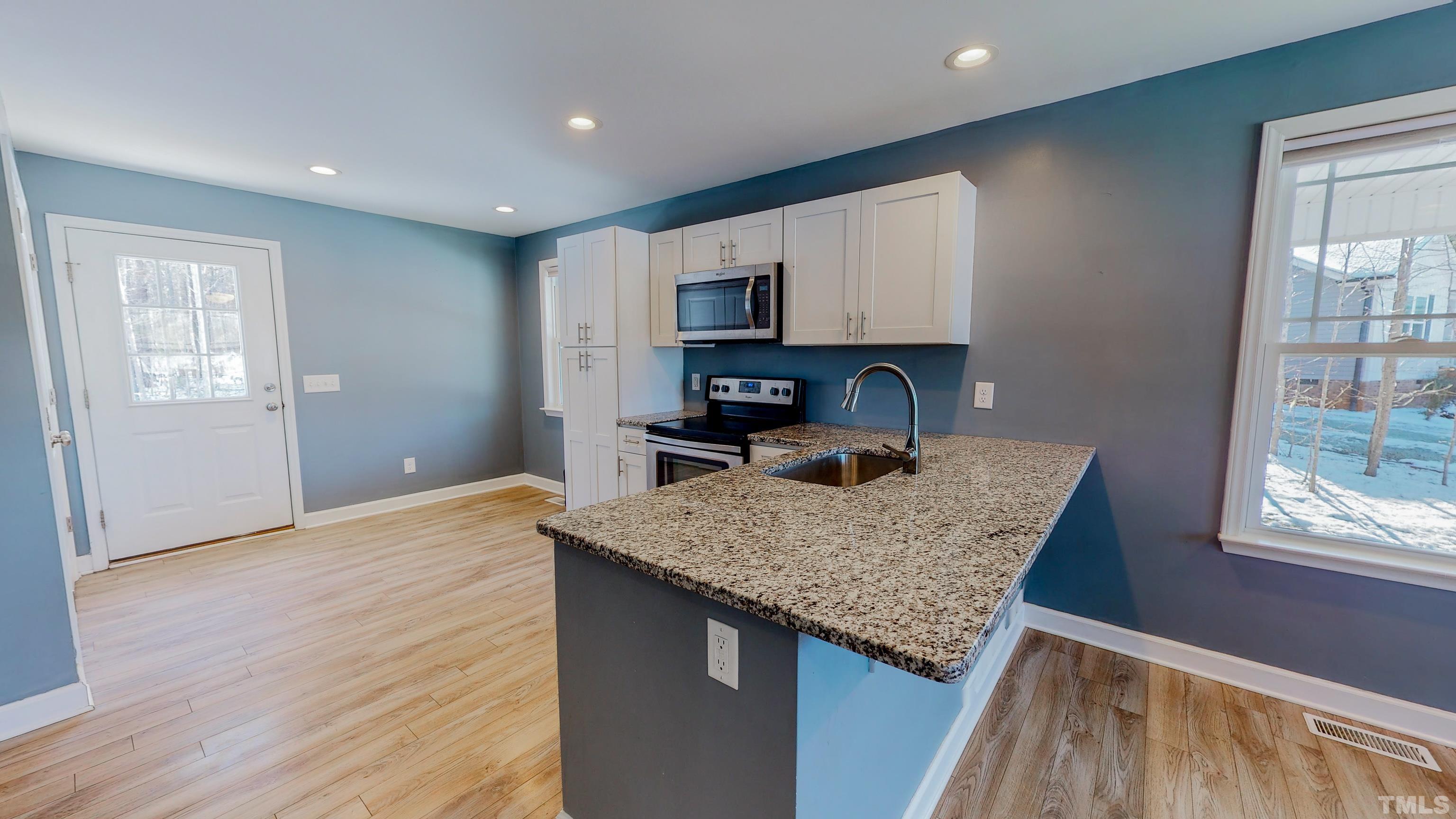 45 Eli Court Roxboro, NC 27573 - Photo 6 of 36 a kitchen with stainless steel appliances granite countertop a sink stove and cabinets