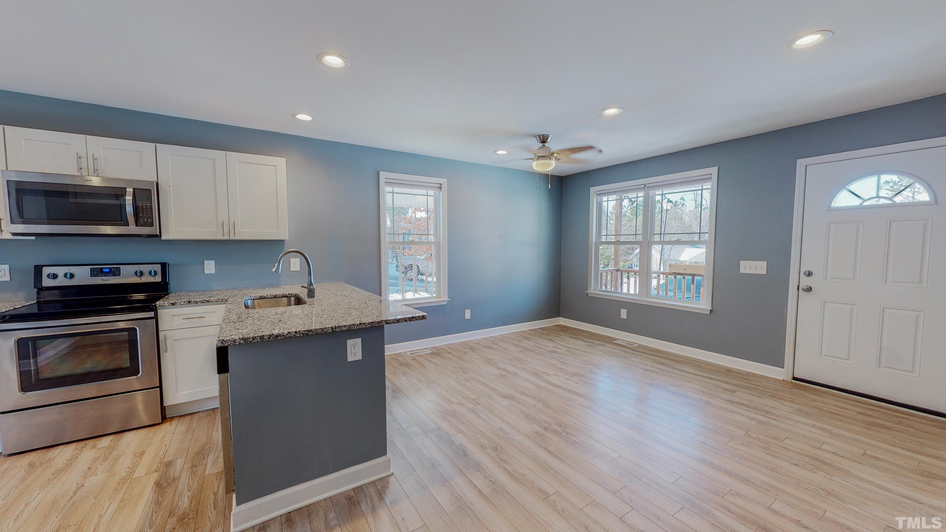 45 Eli Court Roxboro, NC 27573 - Photo 9 of 36 a kitchen with granite countertop a stove and a sink