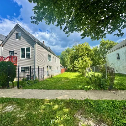 a front view of a house with a yard and trees